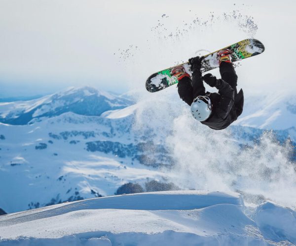 Snowboarder,Jumps,And,Does,A,Trick,In,The,Mountains Snowboarder,Jumps,And,Does,A,Trick,In,The,Mountains
